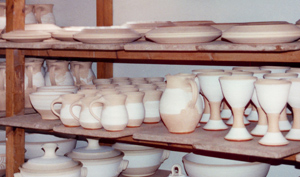 bisqued pots on a shelf
